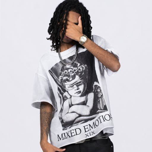 Wrapped gift box with a black mixed emotion tee and a cap on a table
